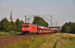 185 317 mit einem Autozug von Mercedes auf der Main-Spessart-Bahn Richtung Gemnden.Aufgenommen bei Thngersheim am 24.7.2012