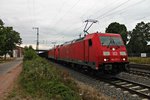 Ausfahrt am 09.06.2015 von 185 277-1 zusammen mit 185 245-8 und einem Tonerdezug aus dem Überholgleis in Müllheim (Baden), nach dem ein ICE sie überholt hatte, in Richtung Basel.