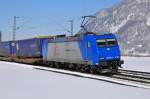 TX Logistik 185 513-9 mit Aufliegerzug in Richtung Brenner kurz vor Kufstein bei Oberaudorf am 10.02.13