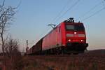 185 129-4 im letzen Sonnenlicht am 08.03.2014 mit einem gemischten Güterzug auf höhe vom Örtchen Hügelheim auf dem Weg in die Schweiz.