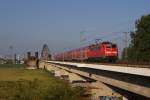 111 129 mit einem RE 4 nach Aachen in Neuss-Rheinpark-Center auf der Hammer Eisenbahnbrcke am 26.06.2011