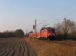 111 144-2 mit RE 14137 Emden Auenhafen-Mnster Hauptbahnhof bei Devermhlen (B 296.6) am 23-3-2012.