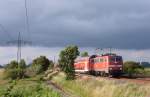 111 137-6 fuhr am 17.07.2012 mit einem RE von Emden nach Münster, hier südlich von Leer.