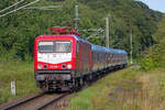 Lok 112 035 mit dem „Strand Express“ auf der Rückfahrt von Binz nach Potzdam hier auf Rügen.