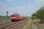 Am 25.04.2011 fhrt 114 018 mit dem RE3 Richtung Berlin, hier bei Chorin.