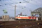 143823 in orangener S-Bahn Lackierung verläßt hier am 24.3.1999 um 16.50 Uhr die Hohenzollernbrücke in Köln und erreicht den HBF Köln.