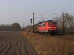 151 058-5 mit einem Gterzug zwischen Emden und Rheine bei Devermhlen am 16-3-2012.