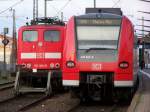 425 623 und 151 014 stehen im Wormser Hbf,die 425 um in wenigen Minuten als RB nach Mani zu fahren,die 151 014 wartet auf den FZ55735 der aus dem Hafen kommt.