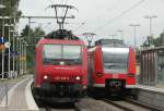 Die 482 018-9 der SBB Cargo begegnet 425 055-1, die gerade als RB33 ihren Halt in Erkelenz macht, aufgenommen am 23.07.2009