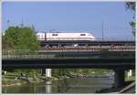 Whrend entlang der Wiese gegrillt, gesonnt und gebadet wird wie im Hochsommer, berquert ein ICE den Fluss etwas nrdlich von Basel Bad Bf. (22.04.2011)