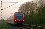 425 064 als RB11078 nach Duisburg Hbf  lie sich am 11.4.09 an der ehem. Anrufschranke in Geilenkirchen fotografieren.