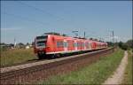 426 029/529 und ein 425er legen sich bei Ostermnchen, als RB 30056 auf der Fahrt von Rosenheim nach Mnchen Hbf, in die Kurve.