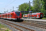 Der Elektrotriebzug 1440 827-2 beim Halt in Wuppertal-Unterbarmen, im Hintergrund die Elektrolokomotive 111 111-1 zieht einen Doppelstockwagen auf dem Weg nach Aachen.