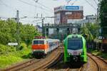 SVG 111 185-5 mit Fußballsonderzug aus Berlin nach Köln, rechts DB 3429 010B als S9 als Parallelfahrt in Wuppertal, Mai 2024.