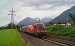 1216 021 mit dem RJ 88 (Bologna Centrale - München Hbf Gl.5-10) am 30.06.2024 kurz vor der Durchfahrt der Haltestelle Münster-Wiesing an der Unterinntalbahn.