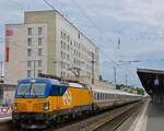 Intercity am Intercity Hotel: 193 500 fährt mit einem Umleiter IC Berlin-Amsterdam über Hannover-Altenbeken-Hamm-Münster-Rheine am neuen Gebäude des Paderborner Hauptbahnhofs ohne Halt vorbei. Juli 2025

