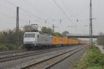 Durchfahrt am 31.10.2016 von RHC 145 084-0 mit ihrem  Bauer -Containerzug aus dem DUSS Weil am Rhein durch die Gleisanlagen vom Bahnhof Müllheim (Baden) gen Freiburg (Breisgau).