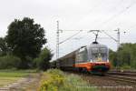 242.516 (Hectorrail - Ferdinand) fhrt am 29. Juli 2011 um 14:33 Uhr mit einem Gterzug durch Halstenbek