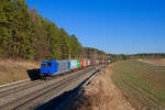 185 520 ATLU mit einem Containerzug bei Hagenbüchach Richtung Würzburg, 09.03.2022