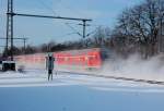 111 125 mit einer RE4 beim Durcheilen von Korschenbroich am 25.12.2010, dank starken Schneefllen am Vortag verwirbelt dieser zu einem feinen Schleier.