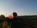 RE 21420 Hamburg Hbf - Lbeck Hbf kurz vor der Einfahrt in Reinfeld (Holst.) bei schon sehr tief stehender Sonne am 28.12.08.