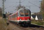 RE11170 als  Fuballsonderzug  von Aachen nach Ahlen (Westf.) mit Schublok 111 010 zwischen Geilenkirchen und Lindern an der ehem.