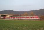 Eine Regionalbahn von Kronach nach Bamberg, bestehend aus 5n-Wagen und einer 111 als Schublok ist am 28. Mrz 2011 auf der Frankenwaldbahn bei Neuses (bei Kronach) unterwegs.