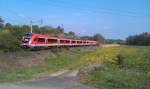 Der  Fahrrad-Regionalexpress  Aschaffenburg - Bamberg durchfhrt am 01.05.2012 mit schiebender BR 111 das Werntal bei Stetten.