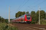 RE 21578 Hamburg Hbf - Lbeck Hbf erreicht am 2.07.09 die ersten Wohngebiete der Stadt Reinfeld (Holst.) und wird gleich einen Zwischenstop in der Karpfenstadt einlegen.