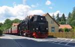 99 7239 durchfhrt mit einem Personenzug vom Brocken kommend am 09.06.12 die Ortschaft Wernigerode Richtung Bahnhof.