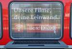  Unsere Filme, deine Leinwand.   Blick in Magdeburg Hbf auf ein Fenster eines Doppelstockwagens, welches Werbung für das neue  BordKINO  in den Zügen der Elbe-Saale-Bahn (DB Regio