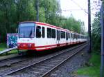 Eine Doppeltraktion aus Stadtbahnwagen B der Dortmunder Stadtwerke vor einem Bahnbergang zwischen Dortmund-Huckarde und Obernette als Zug der Linie U47 nach Westerfilde am 09.