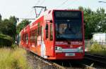 Niederflurwagen 4114 auf der Neusser Strae mit neuer Ganzreklame fr das Mbelhaus Hffner am 02.06.2012