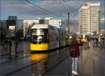Nach einem Regenschauer -    Im nassen Asphalt des Alexanderplatzes in Berlin spiegelt sich die Straßenbahn.