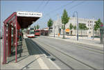 Die Straßenbahn in Freiburg-Rieselfeld -    Im Mittelpunkt des Wohngebietes liegt die Haltestelle Maria-von-Rudloff-Platz' mit der Maria Magdalena Kirche rechts im Hintergrund.