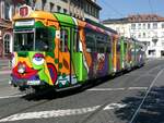 Bis zum Dach bunt bemalt ist die Straßenbahn 204 der Heidelberger Straßen- und Bergbahn AG - HSB -, aufgenommen am 15.09.2003 kurz nach der Abfahrt am zentralen Bismarckplatz in Heidelberg.