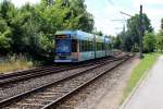 Rostock RSAG: Der Niederflur-Gelenktriebwagen 656 auf der SL 2 nähert sich am 16. Juli 2013 der Haltestelle Dierkower Kreuz. - Im Hintergrund ahnt man den Turmhelm der Petrikirche. 