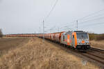 HVLE 246 010 am 09.03.2023 mit einem Getreidezug nach Mukran bei Zirkow Hof (zwischen Samtens und Teschenhagen).