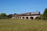 185 538-6 von TXL �berquert hier kurz hinter Naumburg (Saale) eine der beiden Saalebr�cken mit einem Transwaggon-Ganzzug, 01.10.2011.
