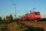 146 235-7 mit einem RE von Basel nach Offenburg im Abendlicht des 09.11.13 beim Verlassen des Bahnhofs Mllheim (Baden).