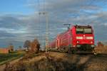 146 116-9 mit einem RE von Offenburg nach Basel Bad. Bf am frhen Abend des 07.12.13 bei der Einfahrt in Mllheim (Baden).