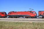 Die 1116 243-7 zwischen 2 Railjetgarnituren bei Übersee am 09.03.2014