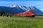 Nach dem Fehlschlag einige Tage zuvor, nahm ich am 13. Juli 2020 einen neuen Anlauf, um die RB 59456 nach München HBF bei Garmisch-Partenkirchen zu fotografieren. Diesmal hat es (fast) wunschgemäß geklappt. Glück hatte ich mit der Bespannung, mit 111 017 führte die aktuell älteste Lok der Baureihe, die im Bh München stationiert ist. Pflegezustand und der Scherenstromabnehmer fielen auch positiv ins Gewicht. Der Blick auf Alpspitze und Zugspitze war klar, die Wiese mit den blühenden Schafgarben war auch noch nicht abgeerntet. Allerdings konnte man feststellen, dass nach dem Lockdown der Flugverkehr wieder aufgenommen wurde, zahlreiche sich auflösende Kondensstreifen zeigten sich bereits zu früher Stunde am Himmel.