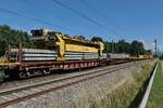 Nachdem der Portalkran die alten Stahlschwellen auf dem ersten Wagen vor dem Gleisumbauzug abgelegt hatte, hat er hier neue Betonschwellen aufgenommen, um diese zum Gleisumbauzug zu transportieren