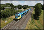 In Höhe der neuen Feuerwache von Hasbergen fährt hier der Eurobahn ET 9.01 nach Münster am 4.7.2022 um 13.25 Uhr in Hasbergen ein.