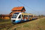 BR 648 Ostseelandverkehr mit Buga-Werbung hlt im Bf. Holdorf. Im Hintergrund das ehemalige Empfangsgebude. 03/2007