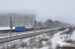 Press 145 023-6 mit leeren Holztransportern am Rande von Berlin,whrend eines starken Schneetreibens,07.01.10 bei Dallgow-Dberitz