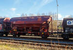 Gedeckter zweiachsiger Schüttgutwagen mit dosierbarer Schwerkraftentladung 21 80 0734 602-4 D-DB, der Gattung Tds 937, der DB Cargo AG abgestellt, im Zugverband eines Übergabezuges der KSW, am 21.02.2023 in Herdorf auf dem Rbf. der KSW.

In diesen Wagen wird Ammoniumnitrat (Gefahrgutnummer 50/1942) zur Sprengstoff Herstellung zur Fa. Dynamit Nobel Defence nach Burbach-Würgendorf gefahren (hier ist er leer). Ammoniumnitrat ist der Stoff von dem ca. 2.750 Tonnen im Hafen von Beirut am 4. August 2020 explodierten und zur der bekannten gewaltigen Explosionskatastrophe führten.

Die Wagen besitzen eine gleisseitige, dosierbare Entladeeinrichtung. Ein Innenanstrich erhöht bei den meisten der Fahrzeuge den Gebrauchswert, insbesondere durch den Schutz vor Verunreinigungen, Möglichkeiten des Transportes von Lebensmitteln, günstigeres Entladeverhalten (Rutschverhalten) bei schwer fließenden Gütern sowie durch verbesserten Korrosionsschutz bei aggressiven Ladegütern.

Der Wagen ist für den Transport von nässeempfindlichen Schüttgütern aller Art, wie z. B. Salze und Düngemittel, vorgesehen. Sie besitzen eine gleisseitige, dosierbare Entladeeinrichtung. Ein Innenanstrich erhöht bei den meisten der Fahrzeuge den Gebrauchswert, insbesondere durch den Schutz vor Verunreinigungen, günstigeres Entladeverhalten (Rutschverhalten) bei schwer fließenden Gütern sowie durch verbesserten Korrosionsschutz bei aggressiven Ladegütern. Der Transport grobkörniger oder kantiger, schwerer Güter (z. B. Kies, Schlacke, Schotter) ist wegen einer möglichen Beschädigung der Innenbeschichtung nicht zulässig.

Das Untergestell und der Wagenkasten sind als Schweißkonstruktion unter Verwendung von Walzprofilen und Blechen hergestellt. Beide Teile sind miteinander verschweißt. Der Wagen besitzt zwei Bühnen, die von beiden Seiten zugänglich sind. Beide Bühnen sind mit einer Sprossenleiter versehen. Die Arbeitsbühne ist mit Handhebeln zur Betätigung der Wölbschieber, mit dem Handrad zur Öffnung des Daches und teilweise mit einer Feststellbremse und Notbremshahn ausgerüstet. Der Neigungsgrad des trichterförmigen Wagenkastens ermöglicht eine restlose selbsttätige Entladung. Die Entladung des Wagens erfolgt über Wölbschieber. Der Wagen ist mit einem einschaligen Hubschwenkdach ausgerüstet. Das Dach wird vor dem Schwenken angehoben und dann seitlich abgeschwenkt, wobei die gesamte Breite der Beladeöffnung freigegeben wird. Im geschlossenen Zustand ist das Dach gegen unbeabsichtigtes Verschwenken gesichert.

TECHNISCHE DATEN:
Spurweite: 1.435 mm
Achsanzahl: 2
Länge über Puffer: 9.640 mm
Achsabstand: 6.000 mm
Laufraddurchmesser: 1.000 mm (neu)
Wagenhöhe: 4.198mm
Größe der Beladeöffnung Länge x Breite: 8.000 x 1.200 mm
Laderaum: 38 m³
Eigengewicht: 13.200 kg
Höchstgeschwindigkeit: 100 km/h (beladen) / 120 km/h (leer)
Maximales Ladegewicht: 26,5 t ab Streckenklasse C
Kleinster bef. Gleisbogenradius: 35 m
Bauart der Bremse: KE-GP (LL)
Bremssohle: IB 116
Intern. Verwendungsfähigkeit: RIV