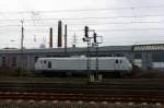 Akiem E37 511 steht abgestellt im Bahnhof Herzogenrath bei Regenwolken am 27.12.2013.