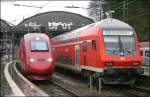 Einmal im Schnee, einmal bei sch�nem Wetter und nun einmal bei sch*** Wetter: Thalys nach Paris Nord und RE9 nach Gie�en nebeneinander in Aachen Hbf 28.3.2009